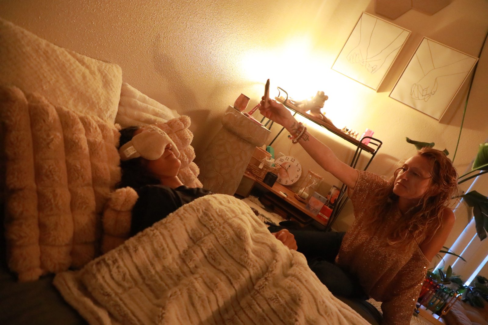 Alicia holding a crystal during energy work, The Wild Within Mesa Arizona