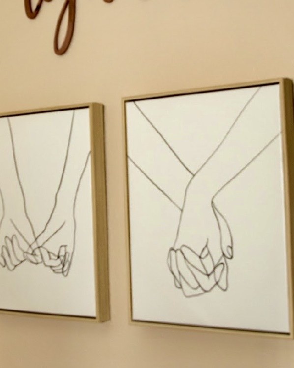 Two framed line drawings of hands linked together, on the wall of the couples counseling room at The Wild Within in Mesa, Arizona